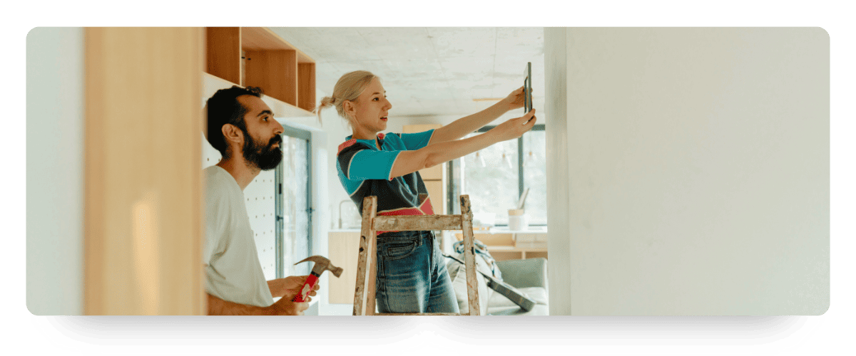 A Couple of Homeowners Evaluating Wall Hanging Placement