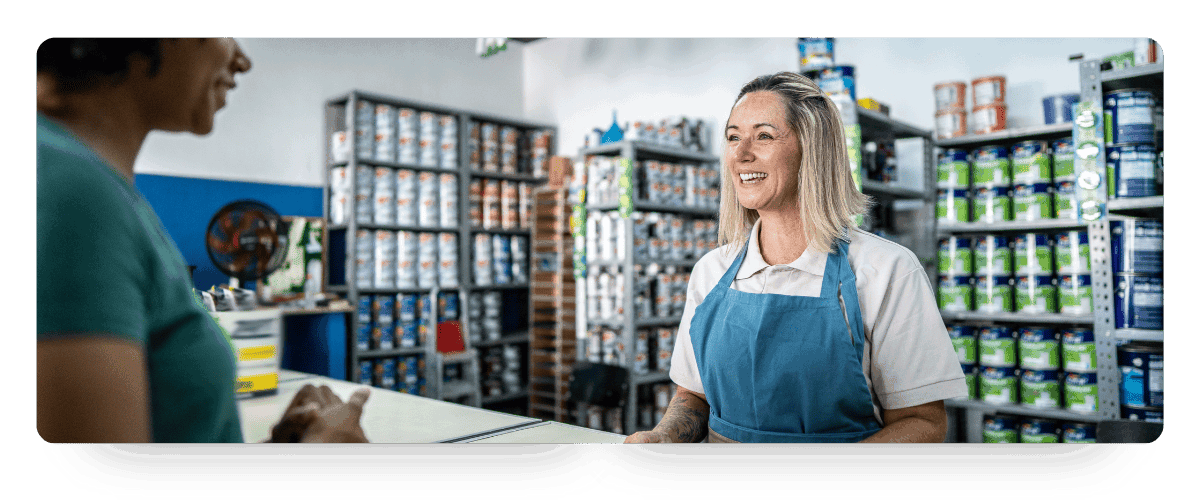 A saleswomen helping a customer at a paint store