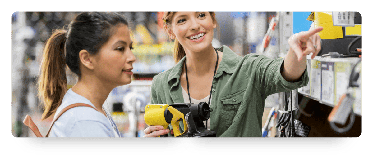 A retail associate helping a customer evaluate products